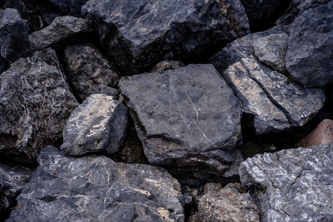 Home A detailed view of stacked, rugged stone boulders showing texture and natural patterns.