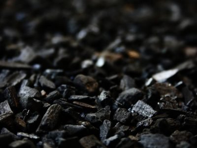 Home Detailed close-up of charcoal briquettes showing textures and shades.