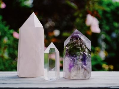 Home A beautiful arrangement of crystals including amethyst and quartz displayed outdoors.