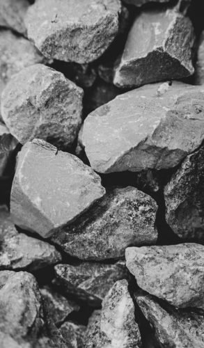 Textured monochrome image featuring rugged stones with selective focus.