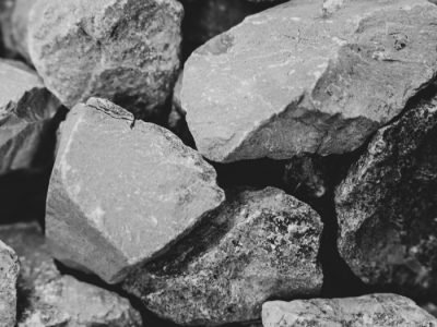 Home Textured monochrome image featuring rugged stones with selective focus.