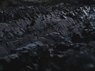 Home A detailed close-up of dark charcoal texture, showcasing its rough and jagged surface.